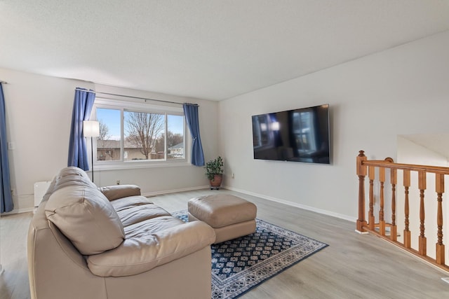 living room featuring baseboards and wood finished floors