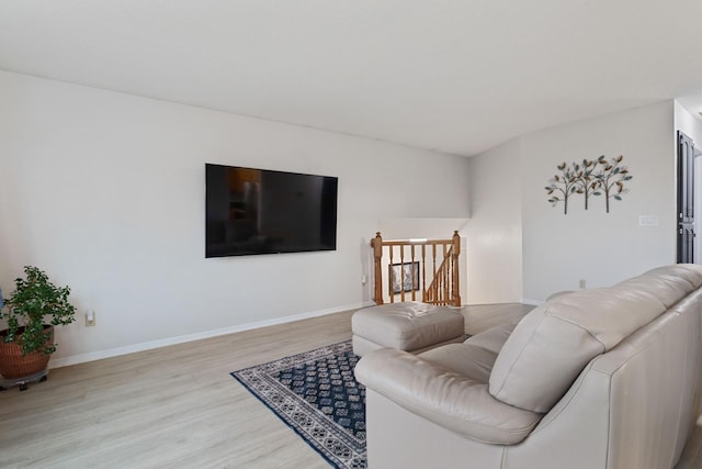 living room featuring wood finished floors and baseboards