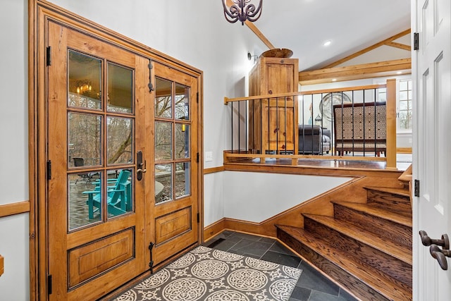 foyer featuring vaulted ceiling, dark tile patterned flooring, baseboards, and recessed lighting