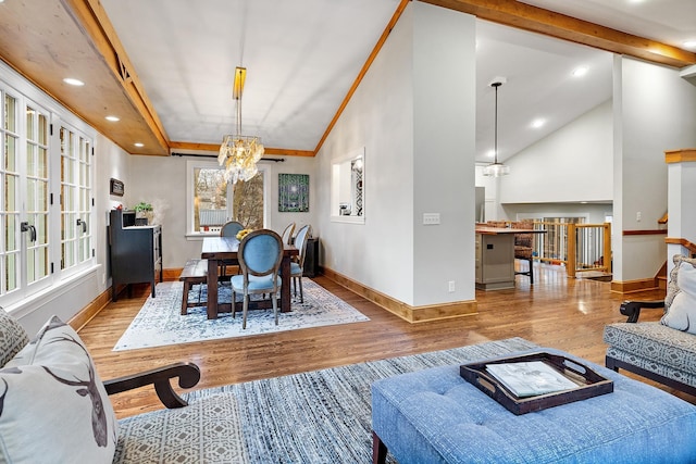 dining room featuring baseboards, wood finished floors, vaulted ceiling with beams, a notable chandelier, and recessed lighting