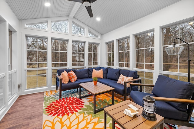 sunroom / solarium featuring vaulted ceiling with beams, a wealth of natural light, and a ceiling fan