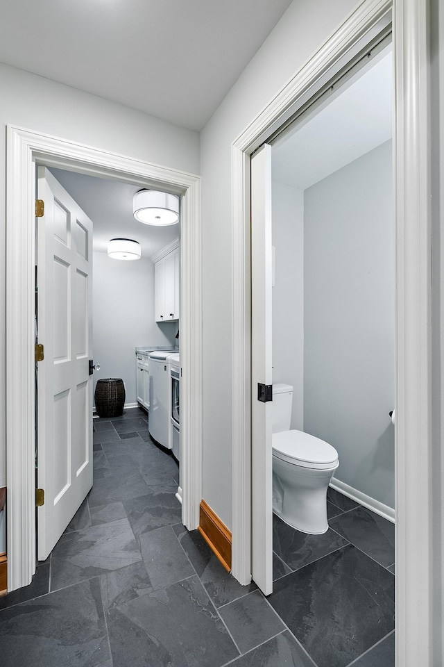 bathroom with vanity, toilet, and baseboards