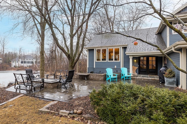 view of patio featuring an outdoor fire pit and french doors