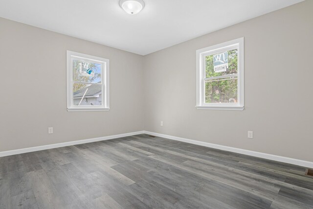 2310 Leona Dr, New Brighton, MN 55112 - unfurnished room featuring healthy amount of natural light, dark wood finished floors, and baseboards