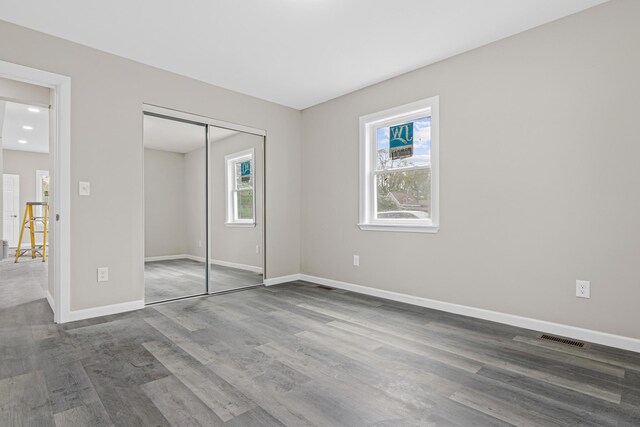 2310 Leona Dr, New Brighton, MN 55112 - unfurnished bedroom featuring wood finished floors, baseboards, and a closet