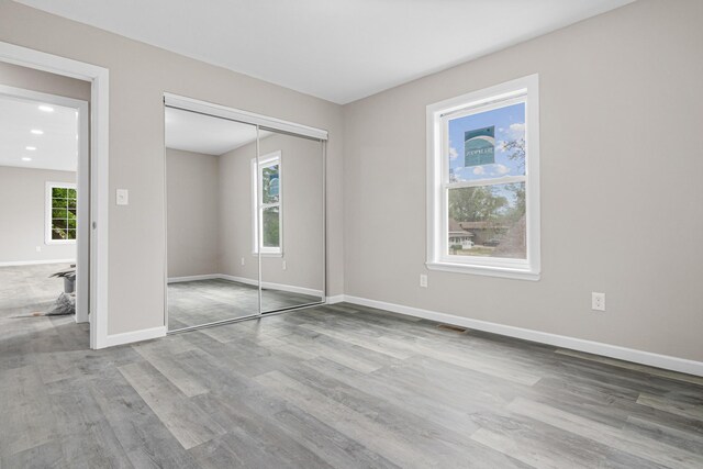 2310 Leona Dr, New Brighton, MN 55112 - unfurnished bedroom with wood finished floors, baseboards, and a closet