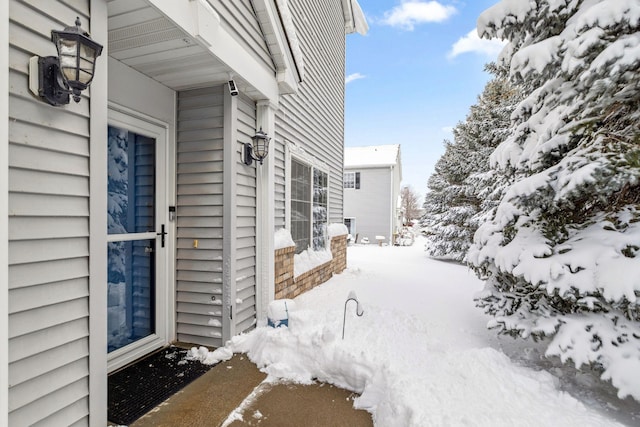 view of snow covered property entrance