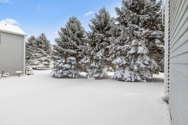 view of yard layered in snow