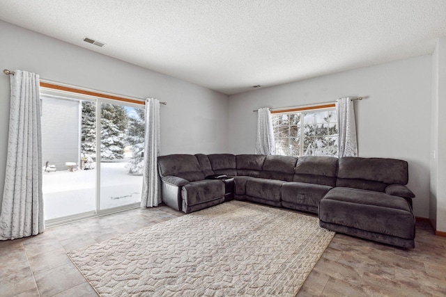 living room featuring a textured ceiling and visible vents