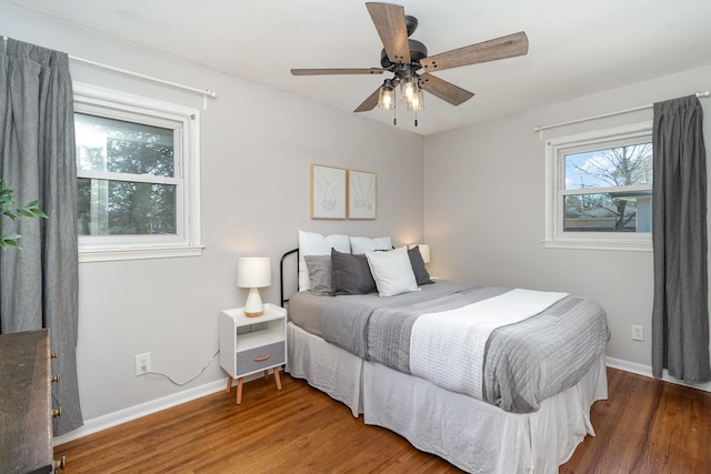 bedroom featuring ceiling fan, baseboards, and wood finished floors