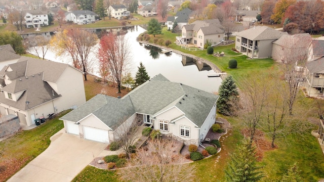 birds eye view of property with a residential view and a water view