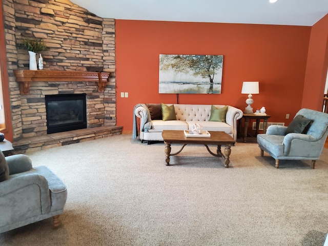 carpeted living room featuring a stone fireplace