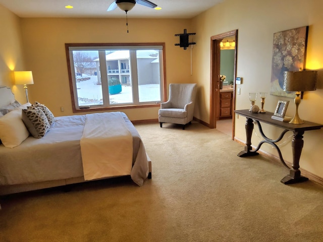 bedroom with light carpet, baseboards, and ensuite bathroom