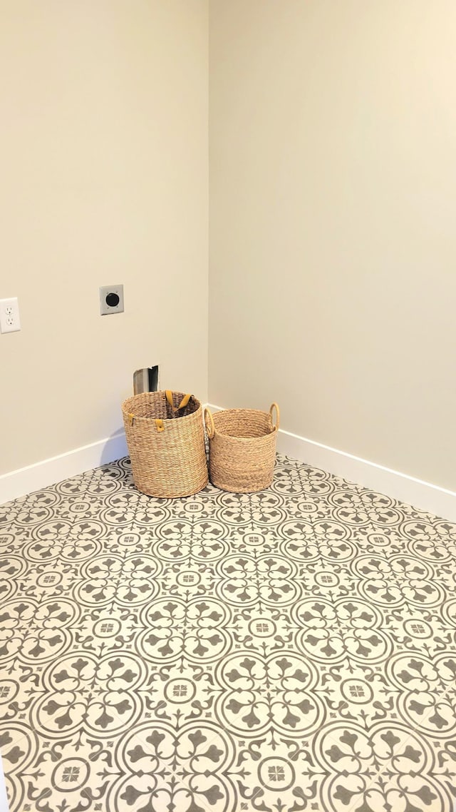 laundry room featuring baseboards, laundry area, and hookup for an electric dryer