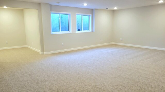 spare room with light carpet, baseboards, and recessed lighting