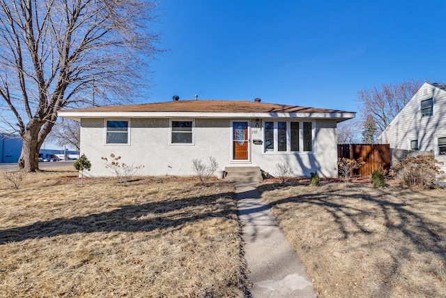 view of front of property with fence and stucco siding