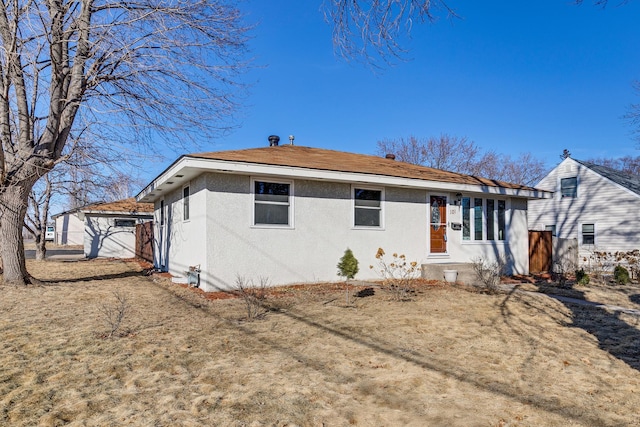 back of property with fence and stucco siding