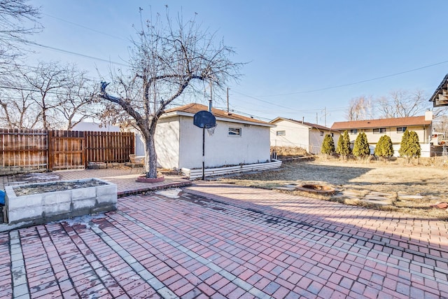 view of patio / terrace featuring an outdoor structure and fence