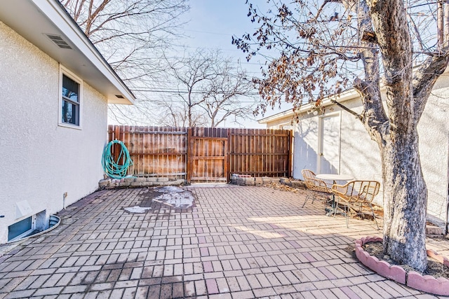 view of patio / terrace featuring fence and visible vents