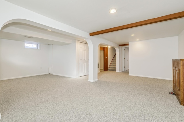 below grade area featuring baseboards, visible vents, light colored carpet, stairway, and recessed lighting