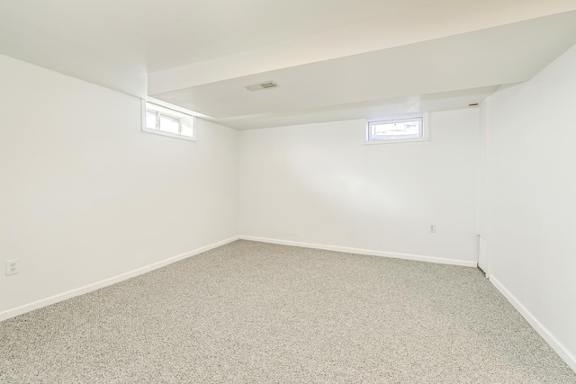 below grade area with carpet floors, baseboards, and visible vents