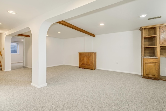 finished basement with light carpet, visible vents, and recessed lighting