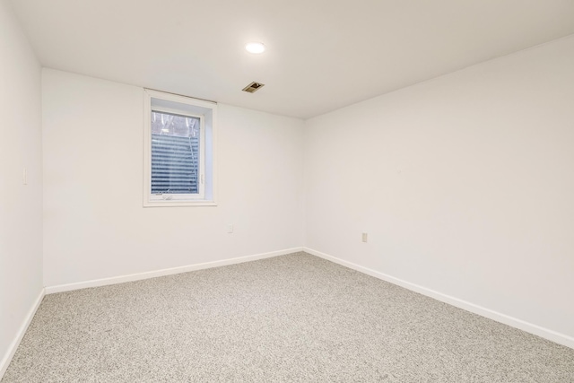 carpeted empty room with visible vents and baseboards