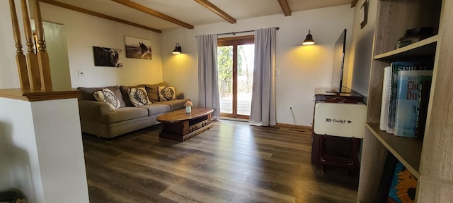 living area featuring beam ceiling and wood finished floors