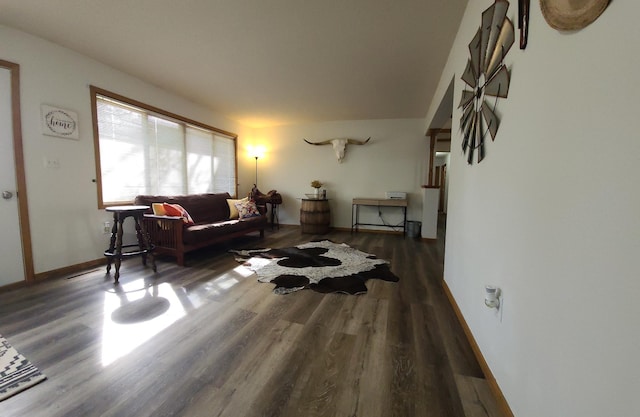 living room featuring wood finished floors and baseboards