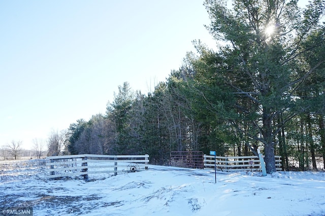 snowy yard featuring fence