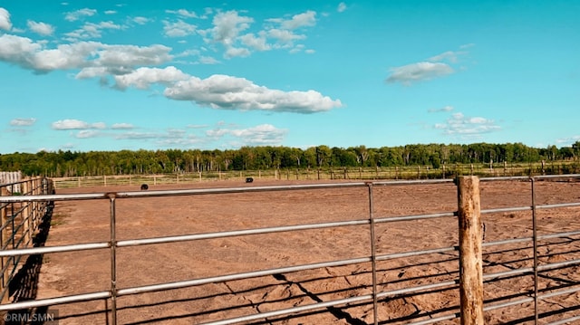 view of yard with an enclosed area and a rural view