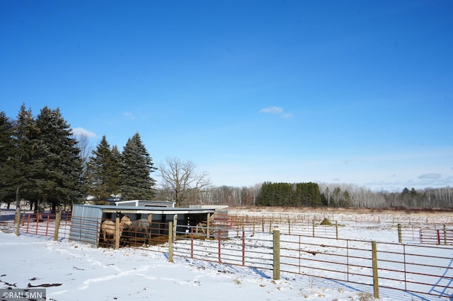 snowy yard with an outdoor structure and fence