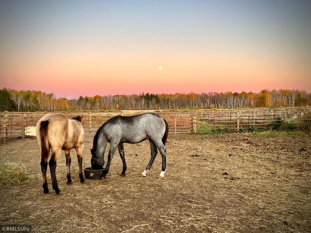 view of horse barn with a rural view