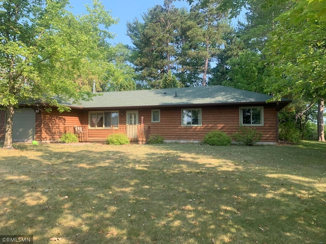 rear view of property featuring a yard