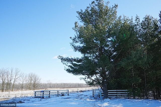 surrounding community with a rural view and fence