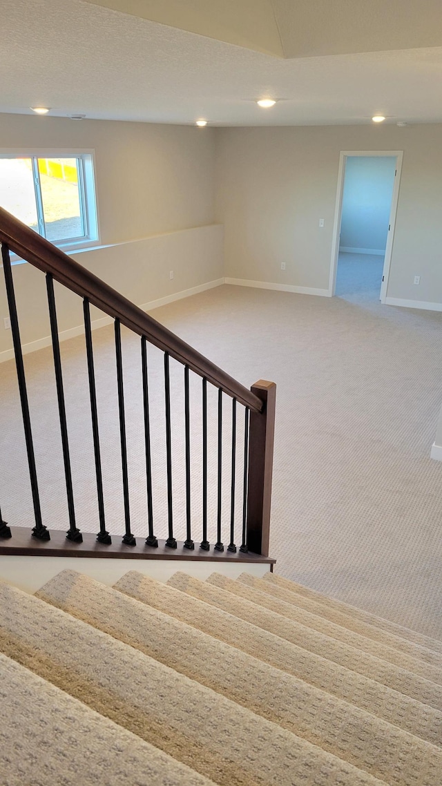 staircase featuring recessed lighting, carpet flooring, and baseboards