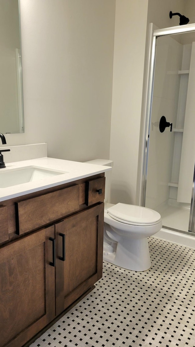 full bathroom with vanity, tile patterned flooring, a shower stall, and toilet