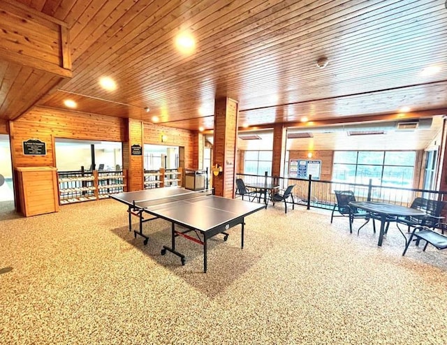 playroom with carpet floors, wood ceiling, and plenty of natural light