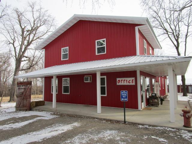 snow covered property featuring metal roof