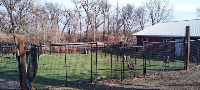 view of yard with fence, an outbuilding, and an outdoor structure