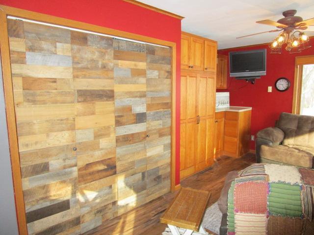 interior space with a ceiling fan and wood finished floors