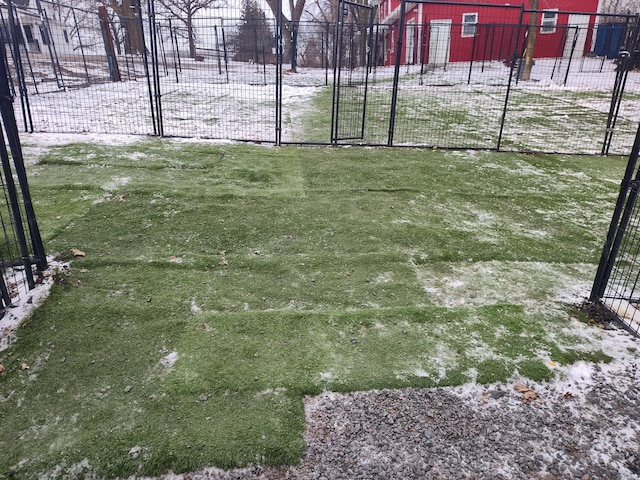 yard layered in snow featuring fence