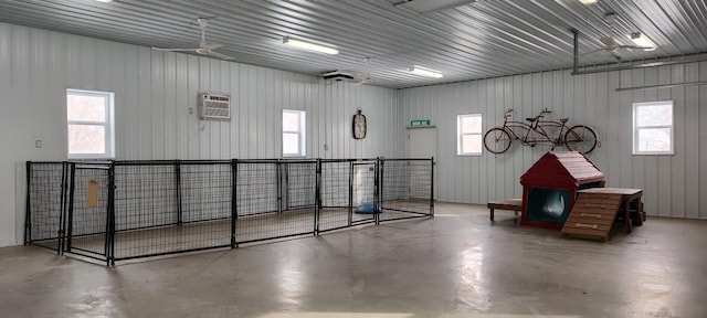 garage featuring an AC wall unit and metal wall