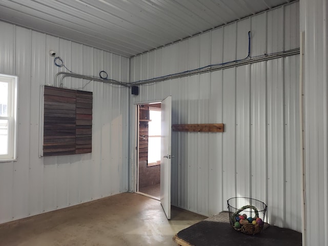 interior space with concrete floors and metal wall