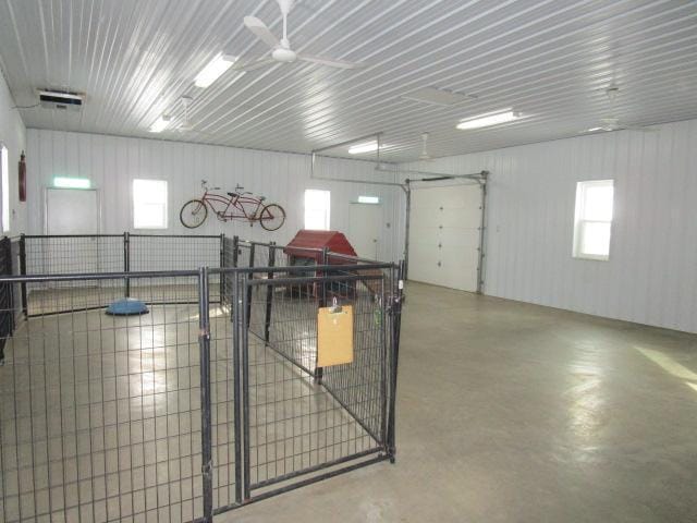 garage with ceiling fan, metal wall, and visible vents