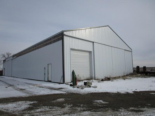 snow covered structure with an outdoor structure