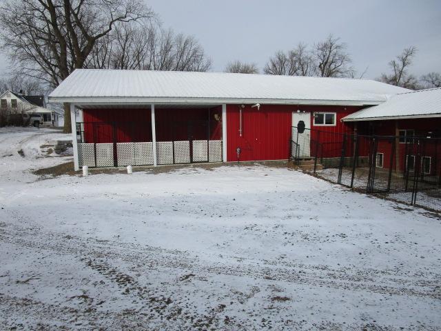 snow covered structure with an outdoor structure