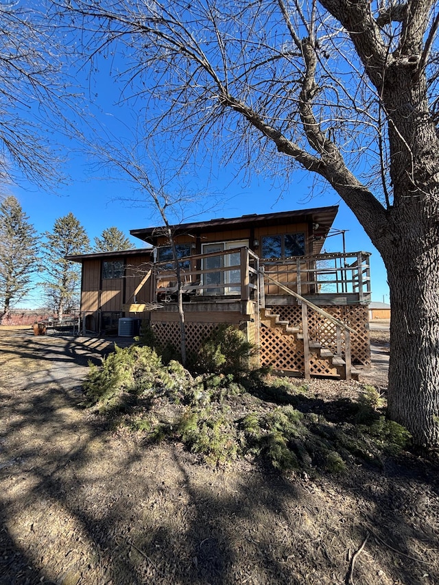 view of front of property featuring stairs and a deck