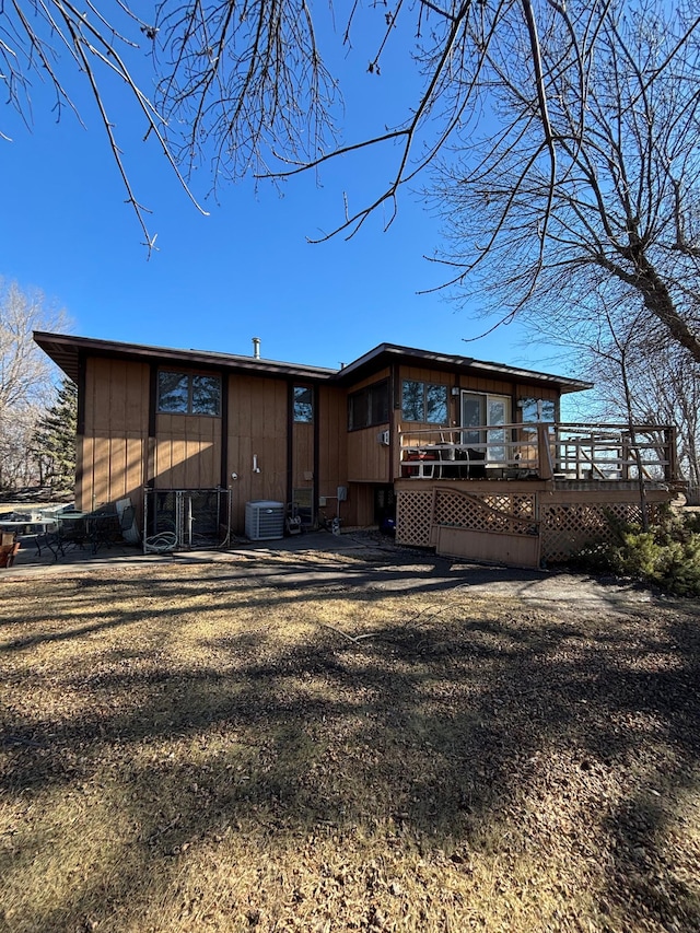 back of property with cooling unit and a deck