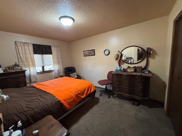 bedroom with carpet floors and a textured ceiling